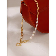 Load image into Gallery viewer, This fashionable necklace comes in a gold colour. It is made of zinc alloy and it is three times gold plated. It is made of big link chain with a combination of pearls. The last link is also a lobster clasp. The necklace is adorned with a hollow heart pedant at its bottom.
