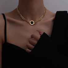 Load image into Gallery viewer, Necklace is made of stainless steel and comes in a gold colour with real gold plating. It is made of a thick link chain which is adorned with double sided medallion. Medallion can be worn on white or black side. It is additionally adorned with engraved roman numerals around its perimeter. Necklace is a real statement piece that will glam up your outfit.
