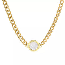 Load image into Gallery viewer, Necklace is made of stainless steel and comes in a gold colour with real gold plating. It is made of a thick link chain which is adorned with double sided medallion. Medallion can be worn on white or black side. It is additionally adorned with engraved roman numerals around its perimeter. Necklace is a real statement piece that will glam up your outfit.
