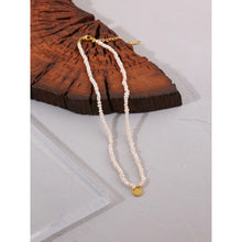 Load image into Gallery viewer, Stylish necklace is handmade of natural pearls in white colour. It is adorned with a little plate in a shape of a circle. The plate is made of stainless steel and comes in gold colour. This necklace is very elegant and it will bring your outfit to a next level. It has adjustable length and lobster clasp. 
