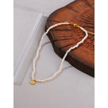 Load image into Gallery viewer, Stylish necklace is handmade of natural pearls in white colour. It is adorned with a little plate in a shape of a circle. The plate is made of stainless steel and comes in gold colour. This necklace is very elegant and it will bring your outfit to a next level. It has adjustable length and lobster clasp. 
