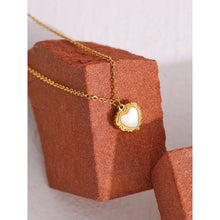 Load image into Gallery viewer, Necklace is made of stainless steel and comes in a gold colour with real gold plating. It is made of a thin elegant chain that is adorned with a heart pedant. Heart pedant is made of shell and it is circled with stainless steel border with interesting engravings. Necklace is a very elegant piece that will glam up your outfit. It has adjustable length and lobster clasp.
