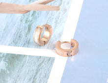 Load image into Gallery viewer, Little hoop earrings are made of stainless steel in a rose gold colour. They are adorned with line of black acryl or white shell. Earrings are three times rose gold plated and represent perfect and elegant touch to your day to day style. They have French closure.
