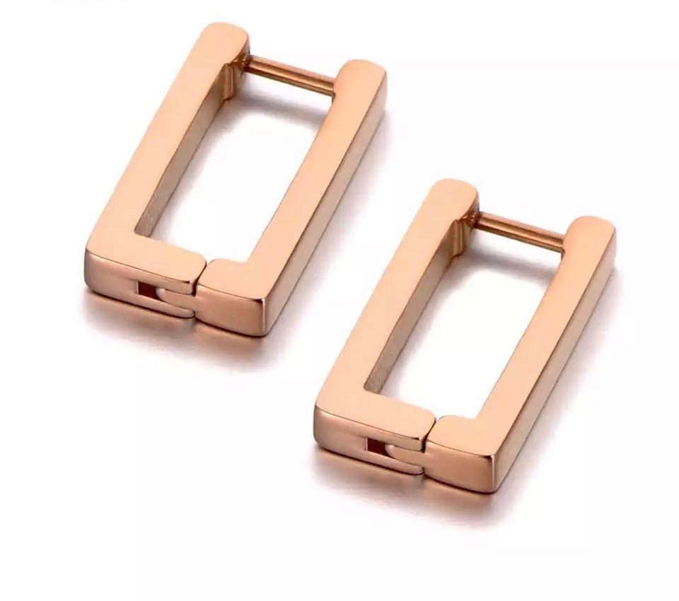 Simple stainless steel hoop earrings are made in a shape of a rectangle. They come in rose gold, gold and silver colour and make a perfect daily accessory. The surface is three times gold plated. It simple design gives you a touch of elegance and class. French lock