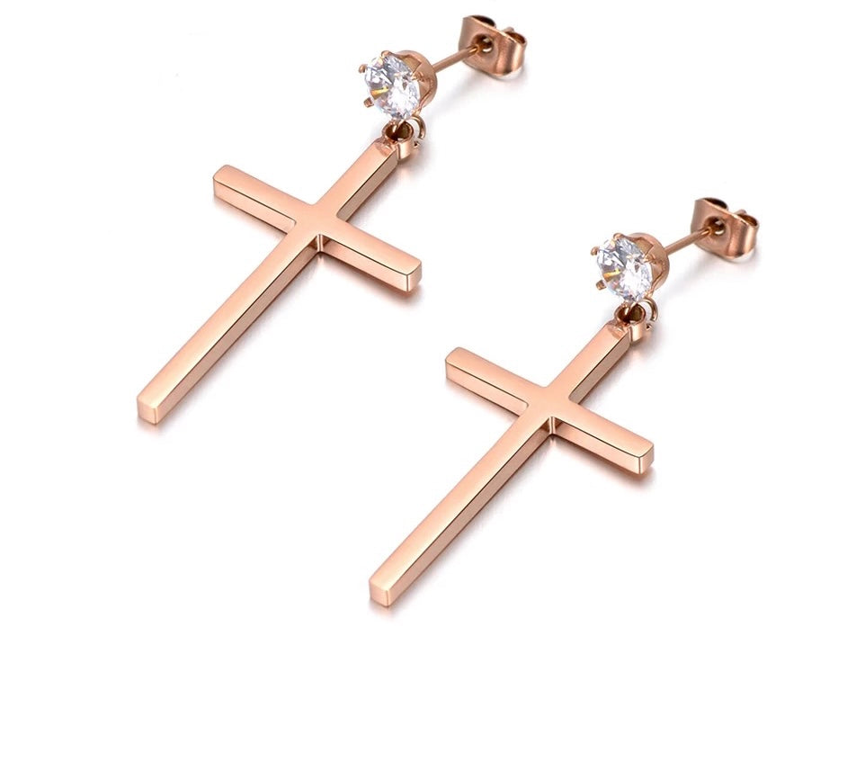 These elegant stainless steel earrings come in a rose gold colour. They are made in a shape of a simple cross which is adorned at its bottom with one sparkling cubic zirconia. Earrings are rose gold plated and represent perfect and elegant touch to your day to day style. They have stud fastening.