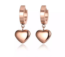 Load image into Gallery viewer, Elegant hoop earrings are made of stainless steel in a rose gold colour. They are adorned with a beautiful heart pedant Earrings are rose gold plated and represent perfect and elegant touch to your everyday outfit. They have French closure.
