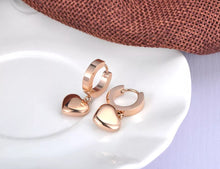 Load image into Gallery viewer, Elegant hoop earrings are made of stainless steel in a rose gold colour. They are adorned with a beautiful heart pedant Earrings are rose gold plated and represent perfect and elegant touch to your everyday outfit. They have French closure.
