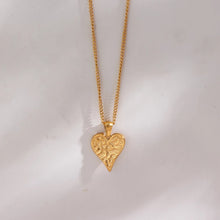 Load image into Gallery viewer, This gorgeous heart pendant necklace is made out of 18K gold plated stainless steel. Heart pedant is adorned with interesting cuts on its surface.The necklace can be perfectly combined with any type of daily or night outfit. It has a size adjustable chain with a lobster clasp. 
