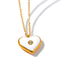 Load image into Gallery viewer, Stainless steel necklace comes in a rose gold colour. It is made of small link chain and it is adorned with a pendant in a shape of a heart. The heart has white enamel layer and small zircon in the middle. This romantic chain necklace is perfect for spicing up both, your daily or evening outfit. It has lobster clasp and adjustable length.
