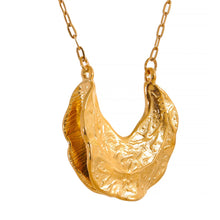 Load image into Gallery viewer, Statement stainless steel necklace comes in a gold colour. It is made of fine thin chain and it is adorned with a nice pendant in the shape of the crescent moon. Interesting shape of the pendant and its irregular surface makes this necklace very glamorous and interesting to be added to any outfit.. It has lobster clasp and adjustable length.
