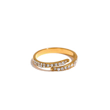 Load image into Gallery viewer, Stainless steel ring in gold colour is adorned with a line of cubic zirconia around its perimeter. The shape of the ring reminds on a snake with its open part at the top. The ring will give your hand a perfect elegance and style.
