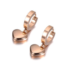 Load image into Gallery viewer, Elegant hoop earrings are made of stainless steel in a rose gold colour. They are adorned with a beautiful heart pedant Earrings are rose gold plated and represent perfect and elegant touch to your everyday outfit. They have French closure.
