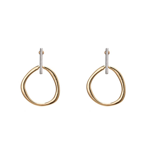 Fashionable and trendy metal earrings are made in a combination of gold and silver colour. They consists of a gold and irregular hollow circle which hangs on a silver stick. Their simplicity gives them very special and glamorous look. Earrings has real gold plating and represent perfect and elegant touch to any outfit. They have stud fastening.