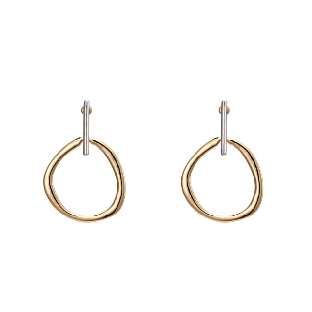 Fashionable and trendy metal earrings are made in a combination of gold and silver colour. They consists of a gold and irregular hollow circle which hangs on a silver stick. Their simplicity gives them very special and glamorous look. Earrings has real gold plating and represent perfect and elegant touch to any outfit. They have stud fastening.