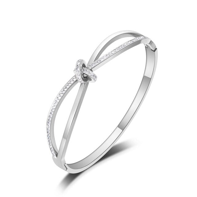 Bangle bracelet is made of stainless steel and comes in two colours: rose gold and silver. It is richly adorned with a bow. The bow has embedded cubic zirconia which makes this bangle perfect accessory for evening night out.