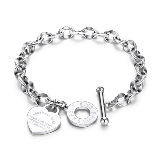 Bracelet is made of stainless steel and comes in three colours: rose gold, gold and silver. It is adorned with a heart pedant with following engraving: 'Above all else guard your heart. For everything you do flows from it'. A big toggle clasp additionally makes it beautiful and statement.