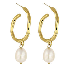 Load image into Gallery viewer, Elegant metal earrings are made in a gold colour. They consists of a big irregular hoop on which a natural pearl is attached. Earrings has real gold plating and represent perfect and elegant touch to your classy and elegant outfit. They have stud fastening.
