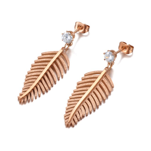 Elegant stainless steel earrings are made in a rose gold colour. They consists of small cubic zirconia on which a leave of fern is hanging. The surface of the fern is sanded which gives the earrings special look. Earrings are rose gold plated and represent great accessory to your elegant outfit. They have stud fastening.