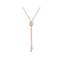 Load image into Gallery viewer, Stainless steel necklace comes in a rose gold colour. It is made of fine thin long chain which is adorned with a beautiful cylinder. Cylinder is additionally decorated with lines of cubic zirconia which makes the necklace perfect accessory for your night out. It has lobster clasp.
