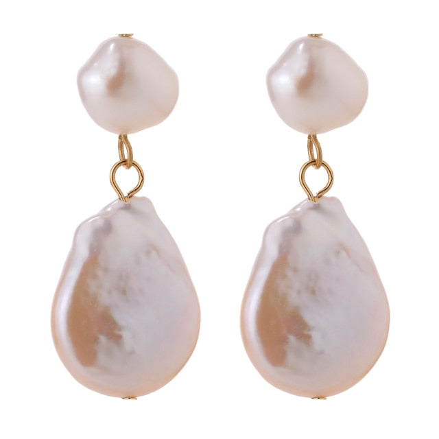 Elegant and luxury earrings are made in a gold colour. They consists of two irregular natural pearls that are hanging one above the other. Lower pearl is bigger than the upper one. Earrings have real gold plating and represent great accessory to your elegant outfit. They have stud fastening.