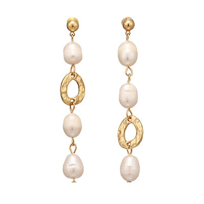 Elegant and classic earrings are made in a gold colour from zinc alloy. They consists of three connected natural pearls and one irregular hollow circle charm. They are connected in different order on each earring so this makes them even more interesting. Earrings have real gold plating and represent perfect and elegant touch to your day to day style. They have stud fastening.