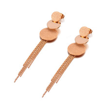 Load image into Gallery viewer, These beautiful earrings are made of stainless steel in a rose gold colour. Earrings have three circles of different sizes, from which two of them have sanded surface. Below three circles earrings are additionally adorned with stainless steel tassel. They make perfect accessory for your evening outfits. Earrings have stud closure.
