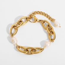 Load image into Gallery viewer, Bracelet is made of stainless steel and comes in a gold colour. This statement bracelet is additionally adorned with freshwater pearls. The length is adjustable with an extra chain that ends with a pearl. This piece of jewelry is perfect accessory for your night out.
