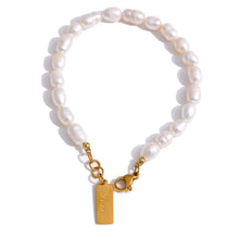 Load image into Gallery viewer, Bracelet is made of stainless steel and white pearls. Pearl bracelet is adorned with a little plate of gold colour. This sophisticated bracelet makes perfect accessory for every evening outfit. It has lobster clasp.
