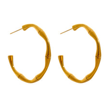 Load image into Gallery viewer, Fashionable hoop earrings are made of stainless steel and come in a gold colour. They have real gold plating and are adorned with a bamboo pattern. Their simplicity and elegance makes them perfect accessory for any outfit. Earrings have stud closure.
