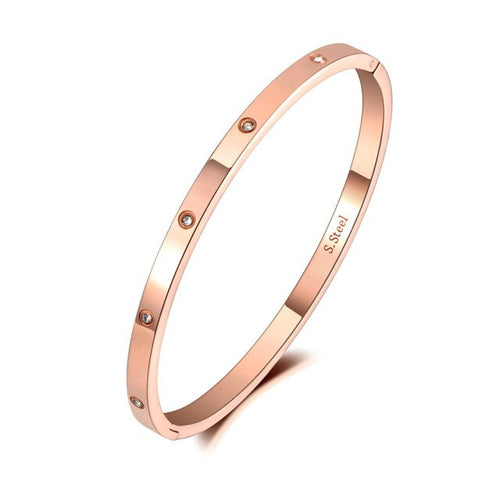 Elegant bangle bracelet is made of stainless steel and comes in four colours: rose gold, gold, black and silver. It is adorned around its perimeter with sparkling cubic zirconia crystals. It is perfect accessory for evening occasions and will sparkle your every outfit.