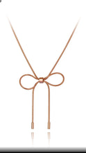 Load image into Gallery viewer, Stainless steel necklace comes in a rose gold colour. It is made of fine thin snake chain which ends with a big bowknot. The necklace is&nbsp;very simple, though makes a perfect accessorize to your outfit. It has lobster clasp.
